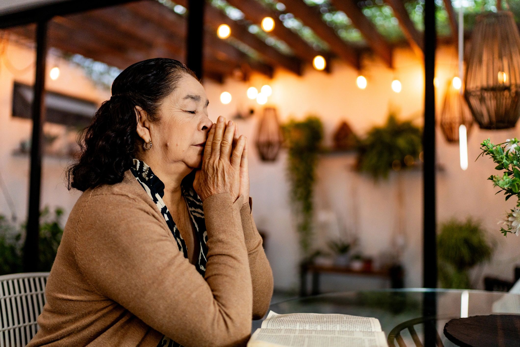 Woman praying quietly at home